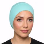 Flat lay of aqua premium soft stretch knitted cotton under scarf cap by SCARF 'N' SHAWLS measuring 24.5 cm x 22 cm