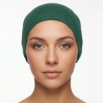 Flat lay of moss-green premium soft stretch knitted cotton under scarf cap by SCARF 'N' SHAWLS measuring 24.5 cm x 22 cm
