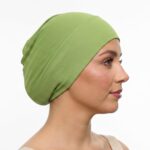 Flat lay of olive-green premium soft stretch knitted cotton under scarf cap by SCARF 'N' SHAWLS measuring 24.5 cm x 22 cm