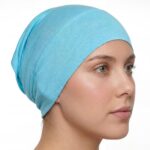 Flat lay of sky-blue premium soft stretch knitted cotton under scarf cap by SCARF 'N' SHAWLS measuring 24.5 cm x 22 cm