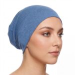 Flat lay of steel-blue premium soft stretch knitted cotton under scarf cap by SCARF 'N' SHAWLS measuring 24.5 cm x 22 cm