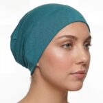 Flat lay of teal premium soft stretch knitted cotton under scarf cap by SCARF 'N' SHAWLS measuring 24.5 cm x 22 cm