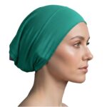 Flat lay of turqouise premium soft stretch knitted cotton under scarf cap by SCARF 'N' SHAWLS measuring 24.5 cm x 22 cm