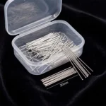 A clear plastic storage box containing fine, silver-toned headless straight pins designed for scarves and turbans, displayed against a black background.