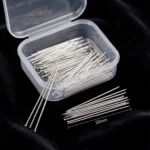 A clear plastic storage box containing fine, silver-toned headless straight pins designed for scarves and turbans, displayed against a black background