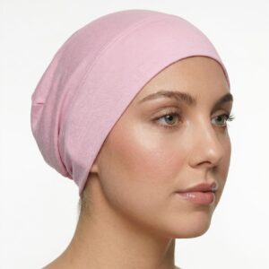 Side profile of a woman wearing a soft, stretchable cotton-candy inner hijab cap against a white background