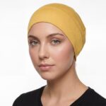 Flat lay of dandelion premium soft stretch knitted cotton under scarf cap by SCARF 'N' SHAWLS measuring 24.5 cm x 22 cm