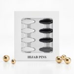 Pack of 8 snag-free hijab safety clips in [Colour Name] displayed in a white window box for scarf and clothing decoration.