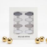 Pack of 8 snag-free hijab safety clips in [Colour Name] displayed in a white window box for scarf and clothing decoration.