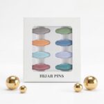 Pack of 8 snag-free hijab safety clips in [Colour Name] displayed in a white window box for scarf and clothing decoration.