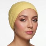 Flat lay of maize premium soft stretch knitted cotton under scarf cap by SCARF 'N' SHAWLS measuring 24.5 cm x 22 cm