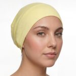 Flat lay of pistachio premium soft stretch knitted cotton under scarf cap by SCARF 'N' SHAWLS measuring 24.5 cm x 22 cm