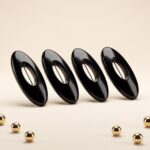 A set of four oval solid-colour safety pin buckles for hijab and scarf styling, featuring a hidden pin design in Midnight Onyx