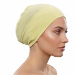 Flat lay of baby-maize premium soft stretch knitted cotton under scarf cap by SCARF 'N' SHAWLS measuring 24.5 cm x 22 cm