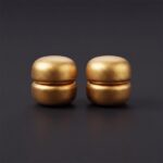 Pair of strong magnetic hijab pins in metallic-gold with a smooth matte finish, designed for snag-free scarf styling.