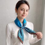 Women's 70x70cm 100% polyester square scarf featuring vibrant prints including floral, styled as a neck accessory or laid flat.