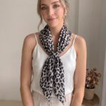 Women's 70x70cm 100% polyester square scarf featuring vibrant prints including floral, styled as a neck accessory or laid flat.